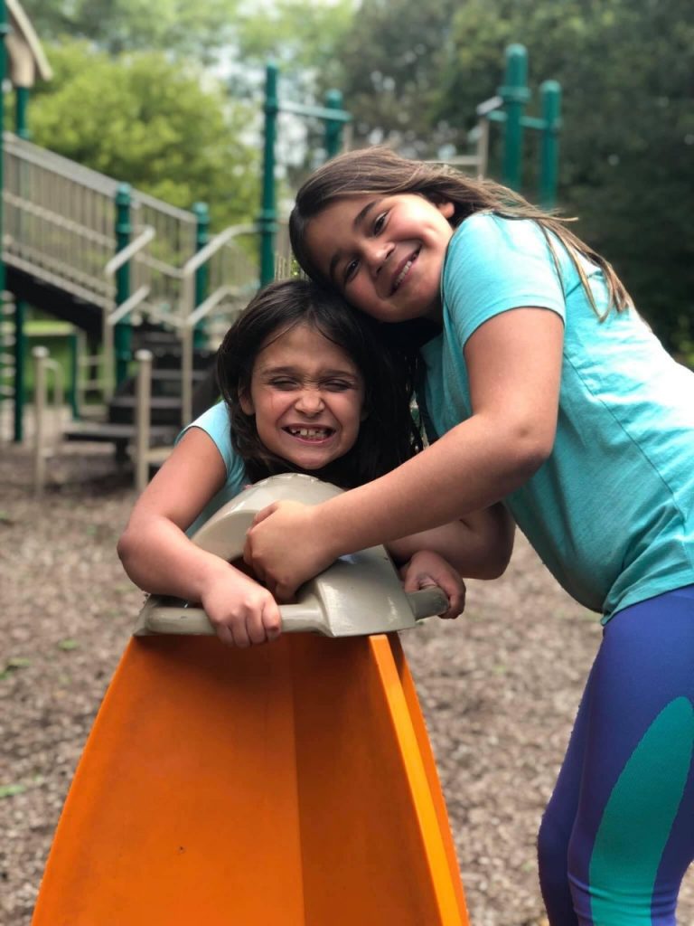 two girls playing on playground